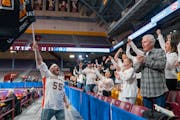 Underwood band director TJ Pelanek leads fans in a chant before a Class 1A girls basketball state tournament semifinals Friday.