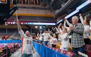 Underwood band director TJ Pelanek leads fans in a chant before a Class 1A girls basketball state tournament semifinals Friday.