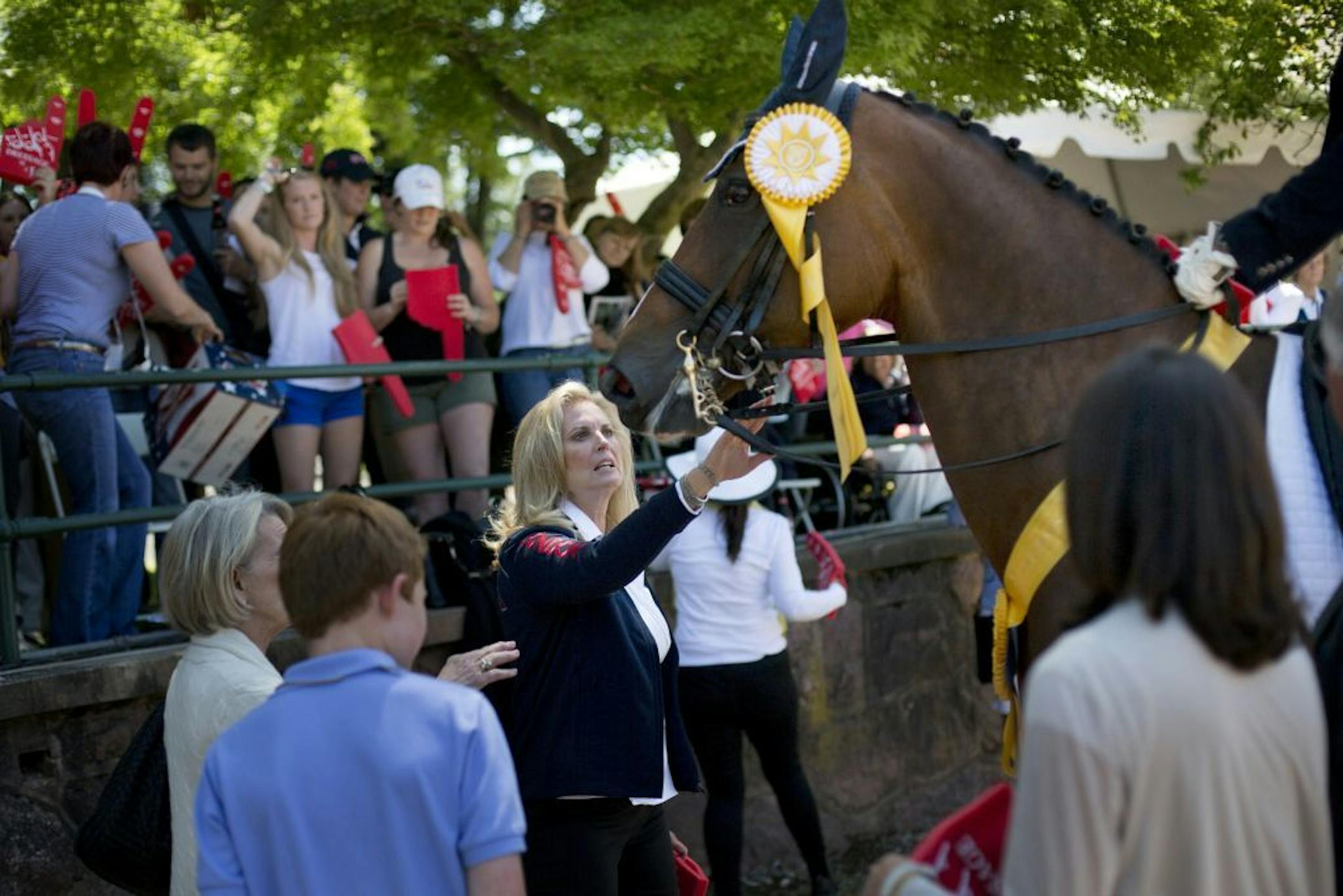 Ann Romney, wife of presumptive Republican presidential candidate Mitt Romney, pets Rafalca, the horse she co-owns with her longtime riding tutor, Jan Ebeling, at a dressage competition in Gladstone, N.J., June 16, 2012. Ebeling and Rafalca earned a berth on the United States Olympic dressage team with their third-place finish in the competition.