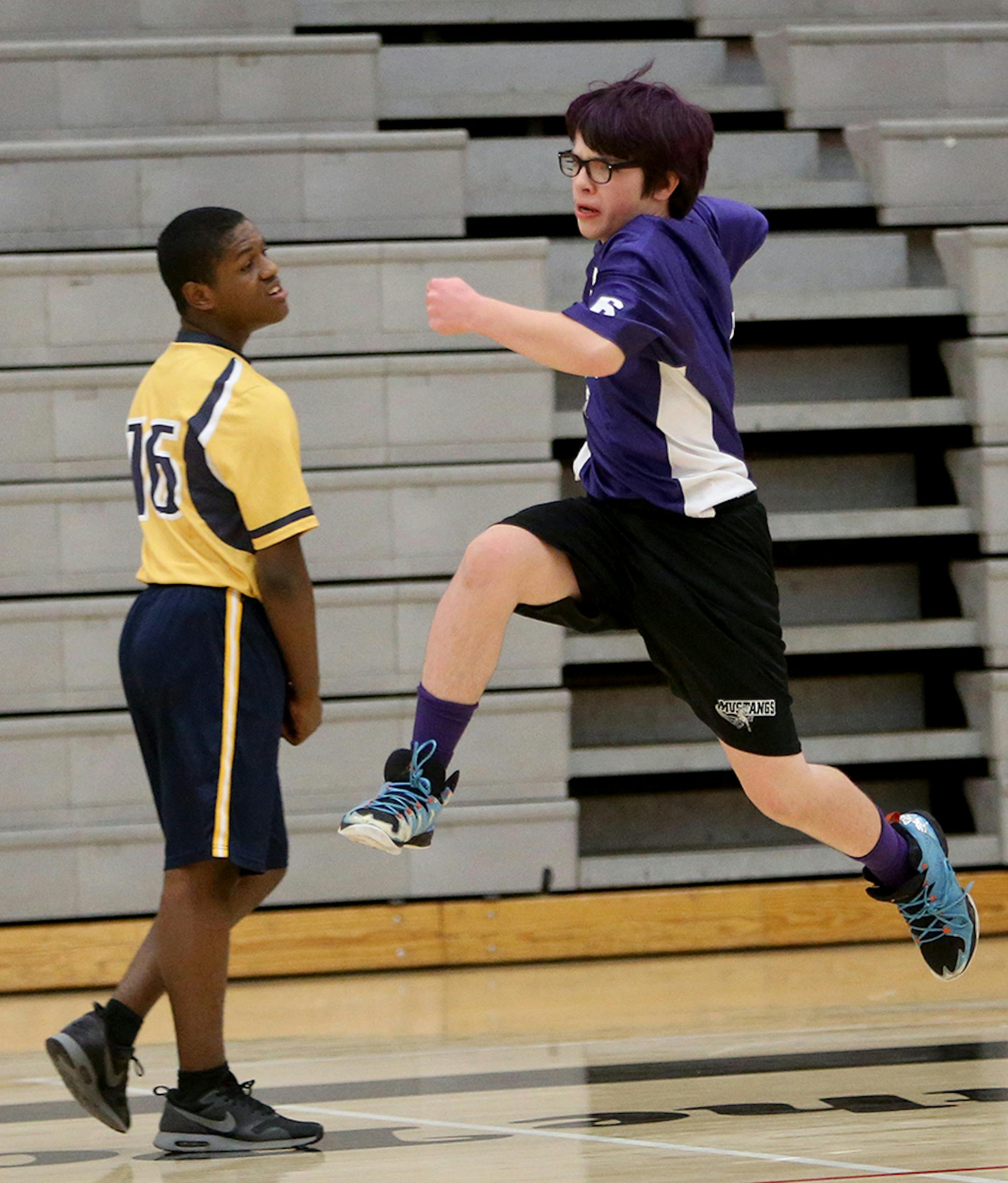 Anoka-Hennepin's Tyler Ezell goes airborne celebrating his first half goal, which proved to be the game winner, Robbinsdale/Hopkins/Mound/Westonka's Izear Joiner (16) during Anoka-Hennepin 's 2-0 win.