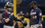 Minnesota Twins' Miguel Sano, right, celebrates with teammate Mitch Garver after defeating the Tampa Bay Rays, 907, in a baseball game Sunday, June 2,