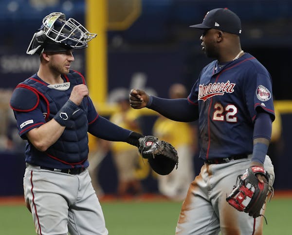 Minnesota Twins' Miguel Sano, right, celebrates with teammate Mitch Garver after defeating the Tampa Bay Rays, 907, in a baseball game Sunday, June 2,