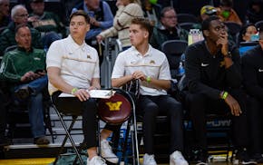 Gophers men's basketball student manager Drew Evenson, left, has been an inspiration for the team.