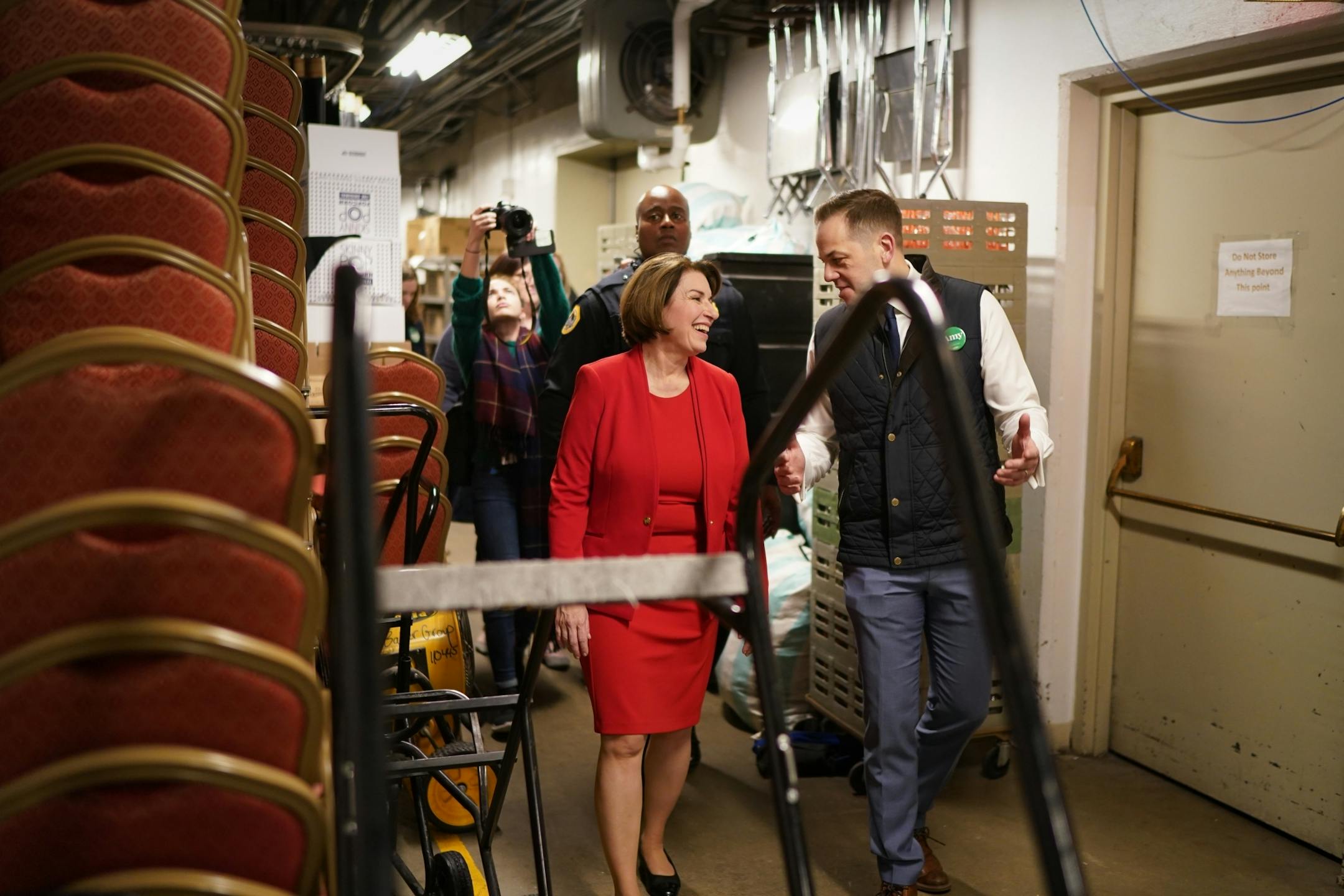 With campaign manager Justin Buoen at her side, Amy Klobuchar walked backstage to greet almost 100 staffers gathered in the war room behind the stage in Des Moines.