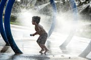 With temperatures cracking 90, Roman Ramos, 3, had a blast in the water pad at at Kelley Park in Apple Valley with his mom Jordan on Tuesday, Septembe