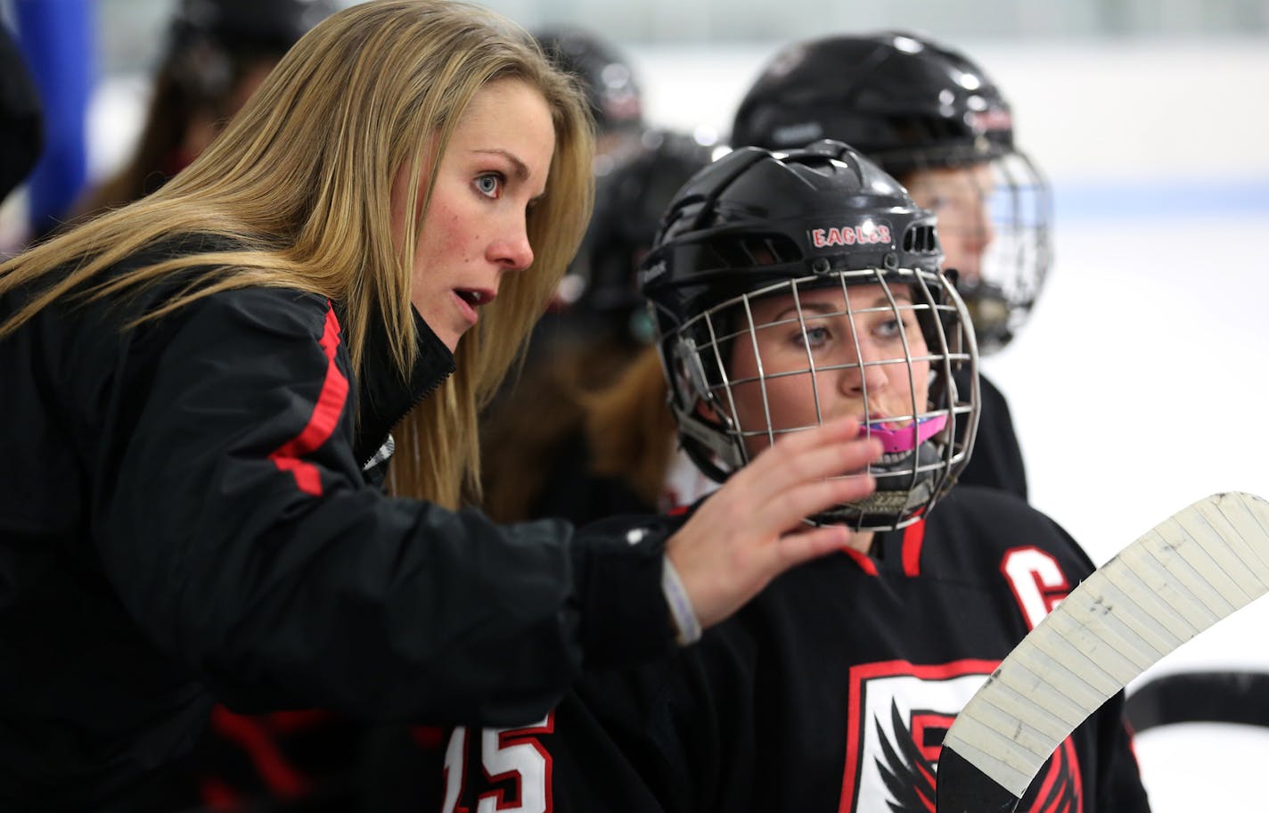 Christina Lee, assistant coach of Eden Prairie gave instruction to Ashley Astor on the bench before her shift. ] (KYNDELL HARKNESS/STAR TRIBUNE) kyndell.harkness@startribune.com Eden Prairie vs. Cretin-Derham Hall girls' hockey game at Highland Arena in St Paul Min., Tuesday, December 23, 2014.