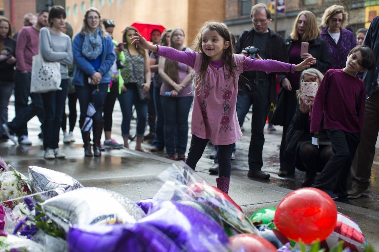 After spending the day dancing to Prince music, 7-year-old Graciella Victoria was in awe of all the flowers as she visited a memorial to the music legend at First Avenue on Thursday night.