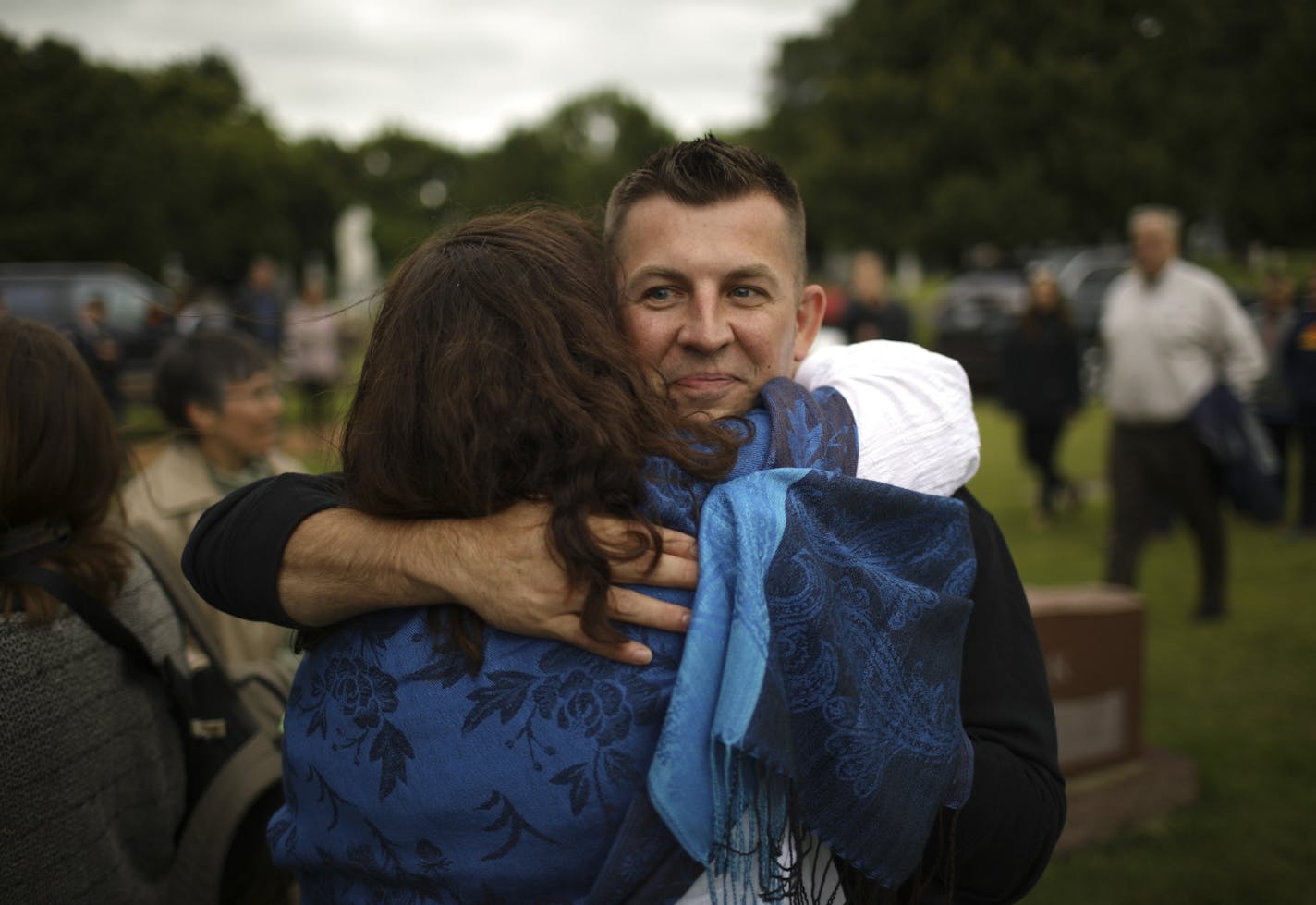 Jesse Richard hugged his aunt, Patty Thornton, after she arrived at Calvary Cemetery in Jordan for the memorial service for her brother, Thomas Breunig, Jesse's father.