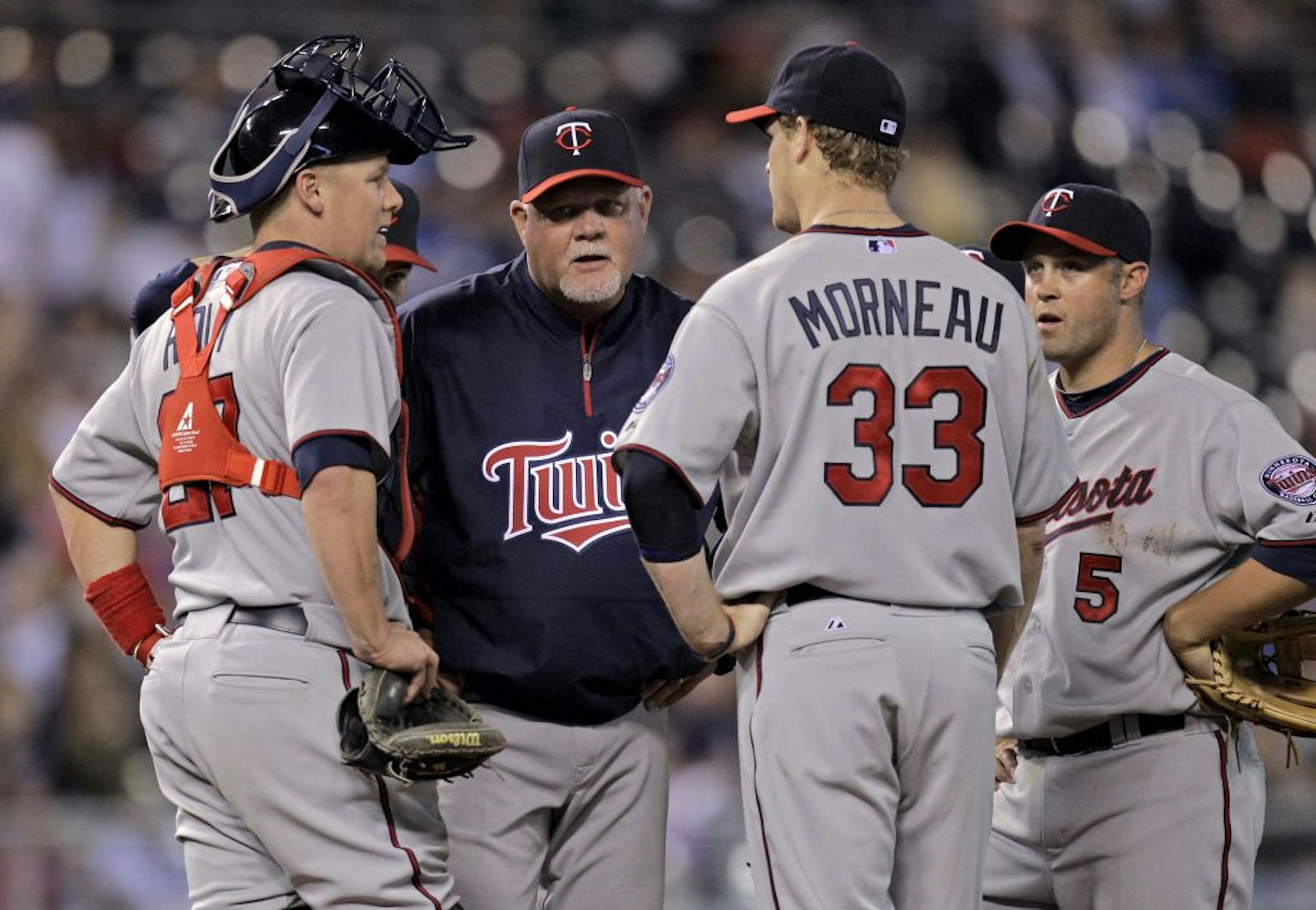 Minnesota Twins manager Ron Gardenhire talks to his players during a pitching change in the eighth inning of a baseball game against the Kansas City Royals Saturday, April 30, 2011, in Kansas City, Mo. Kansas City won the game 11-2.
