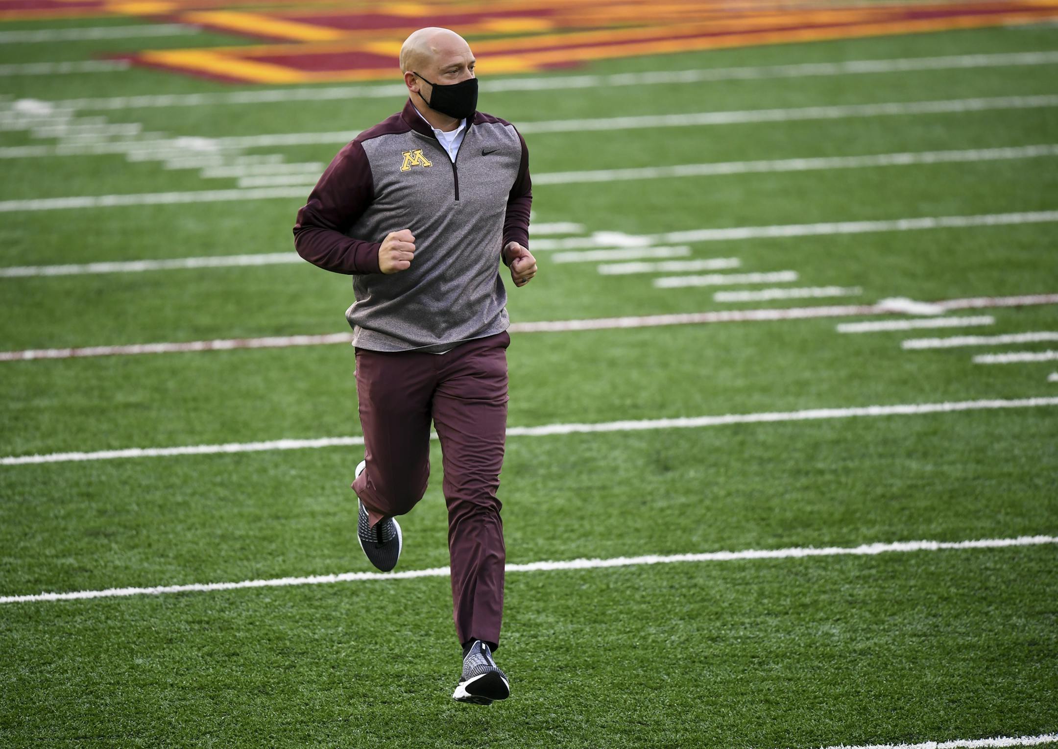 Minnesota Gophers head coach P.J. Fleck ran back to the team tunnel after visiting with players on the field before Saturday night's game against the Michigan Wolverines. ] AARON LAVINSKY • aaron.lavinsky@startribune.com The Minnesota Gophers played the Michigan Wolverines on Saturday, Oct. 24, 2020 at TCF Bank Stadium in Minneapolis, Minn.