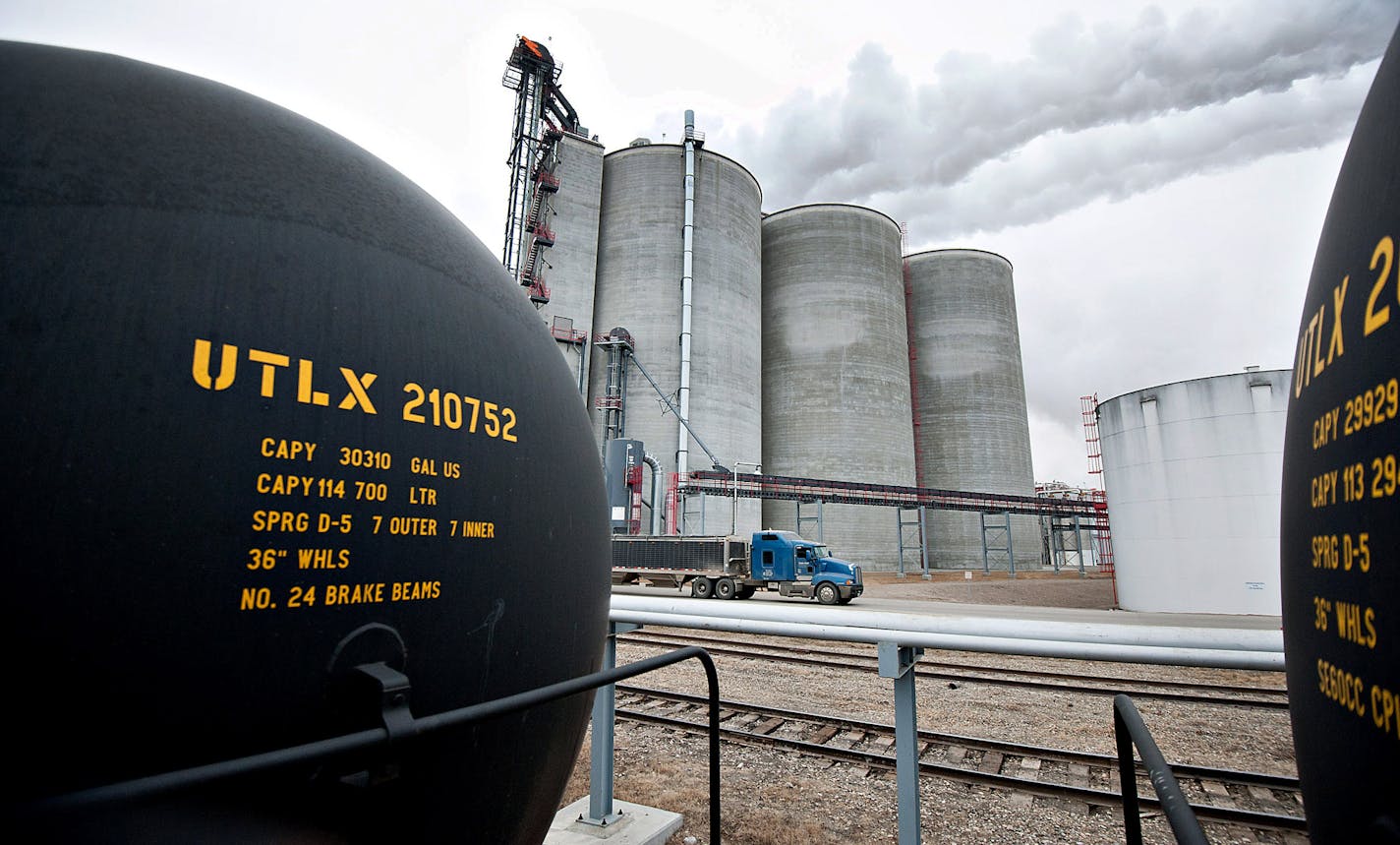 Grain storage silos stand beyond tanker railcars used to transport denatured alcohol, or ethanol, at the Great River Energy Blue Flint Ethanol plant in Underwood, North Dakota, U.S., on Thursday, Feb. 9, 2012. North Dakota will hold its Republican presidential caucus on March 6. Photographer: Daniel Acker/Bloomberg ORG XMIT: 140227233