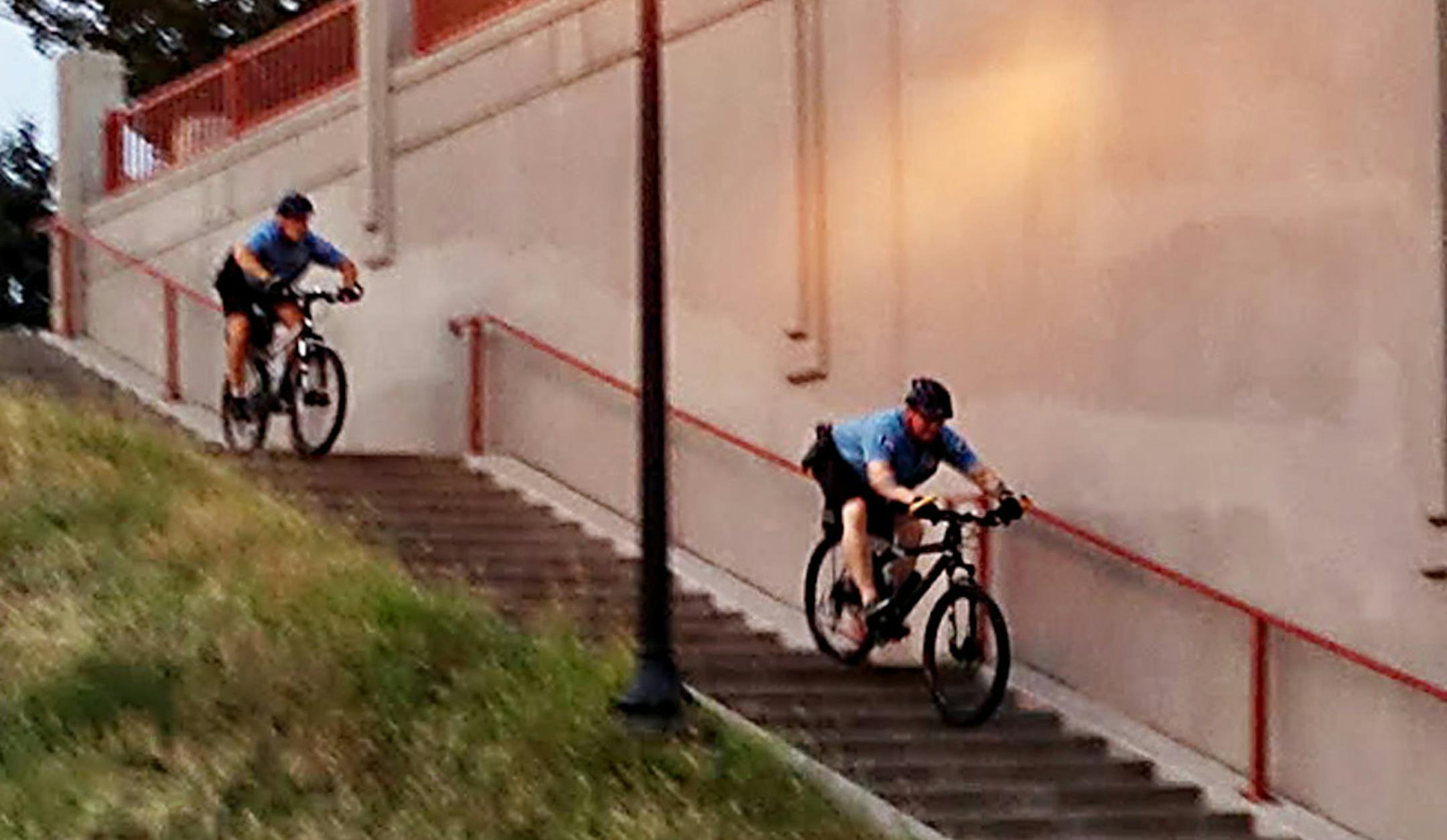 ERIC ROPER/ STAR TRIBUNE. Officers Jim Bulleigh and Dan Lysholm demonstrate riding their police bicycles down stairs on the Midtown Greenway.