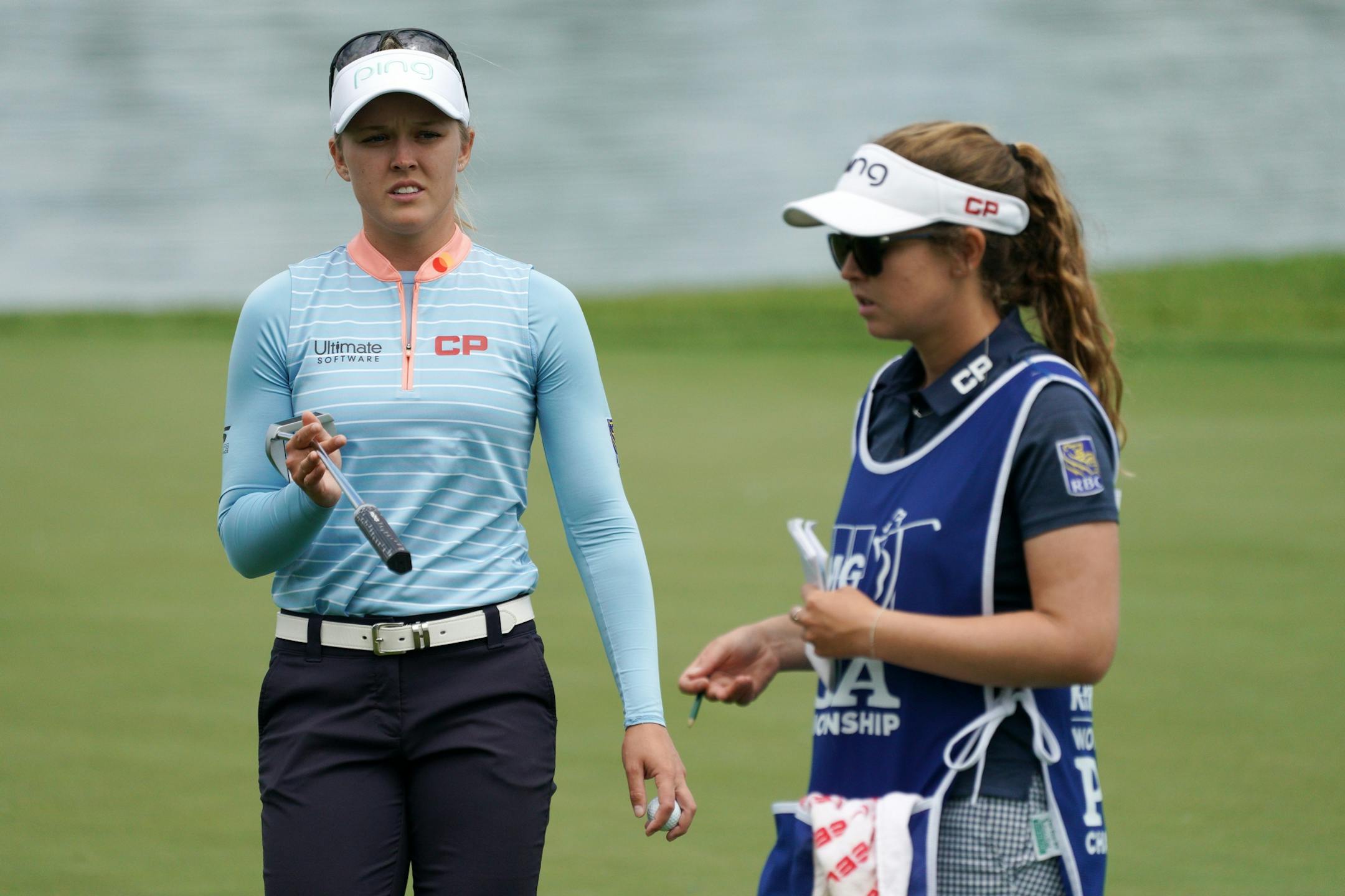 Brooke Henderson haded off her putter to her caddie on the 16th green Tuesday afternoon.