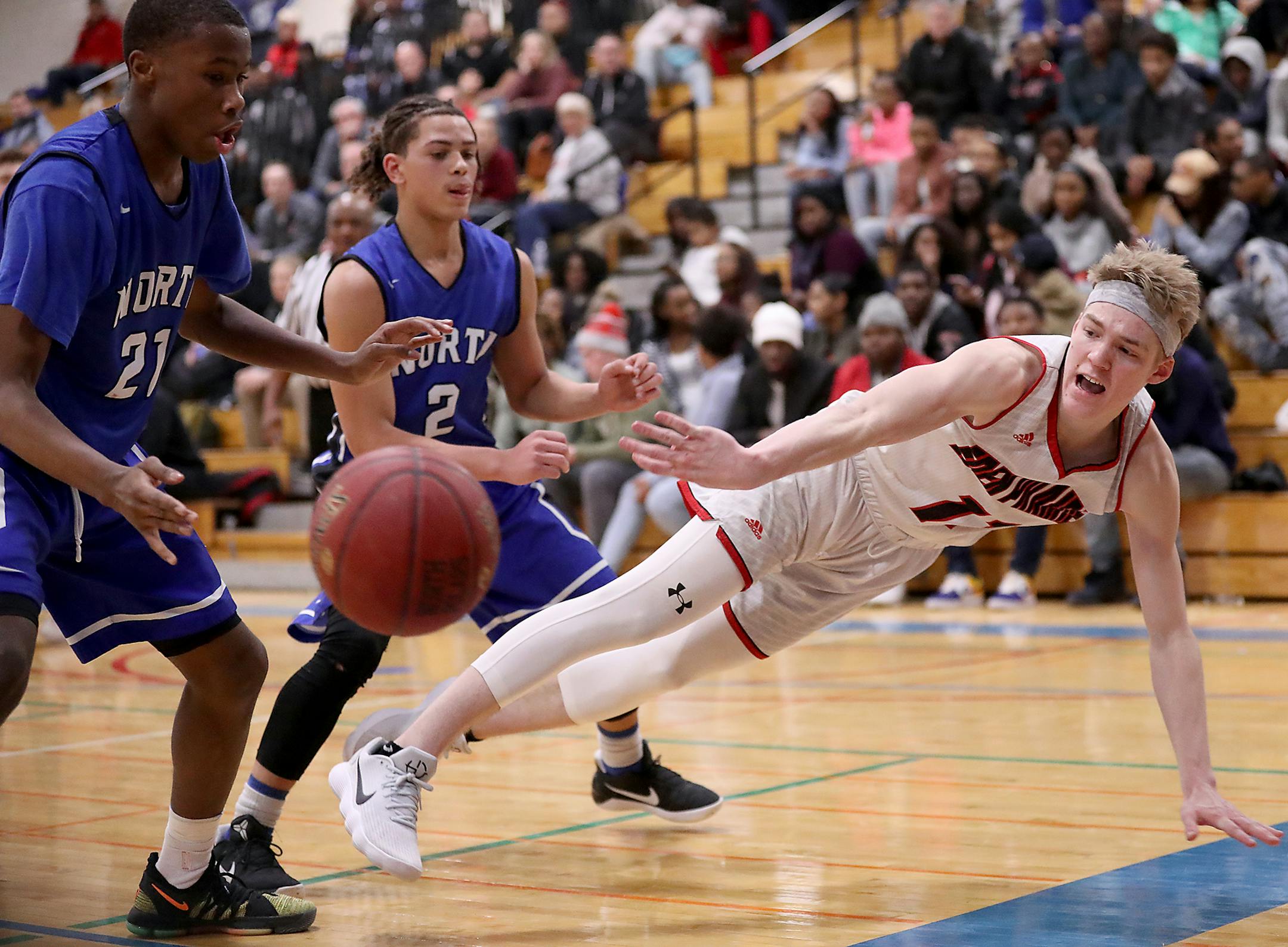 Drake Dobbs (11) of Eden Prairie makes a diving pass as Trej Holloman (21) of Minneapolis North and Eli Campbell (2) of Minneapolis North defend during the second half. ] LEILA NAVIDI ï leila.navidi@startribune.com BACKGROUND INFORMATION: Eden Prairie against Minneapolis North boys basketball at Minneapolis North Community High School in Minneapolis on Wednesday, January 3, 2018. Eden Prairie won the game 69-57.