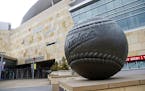 A giant baseball sculpture sits outside Target Field, home of the Minnesota Twins baseball team, Wednesday, March 25, 2020 in Minneapolis. Though the 