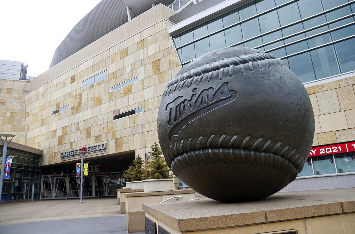 A giant baseball sculpture sits outside Target Field, home of the Minnesota Twins baseball team, Wednesday, March 25, 2020 in Minneapolis. Though the Twins would open on the road, the start of the regular season is indefinitely on hold because of the coronavirus pandemic. (AP Photo/Jim Mone)