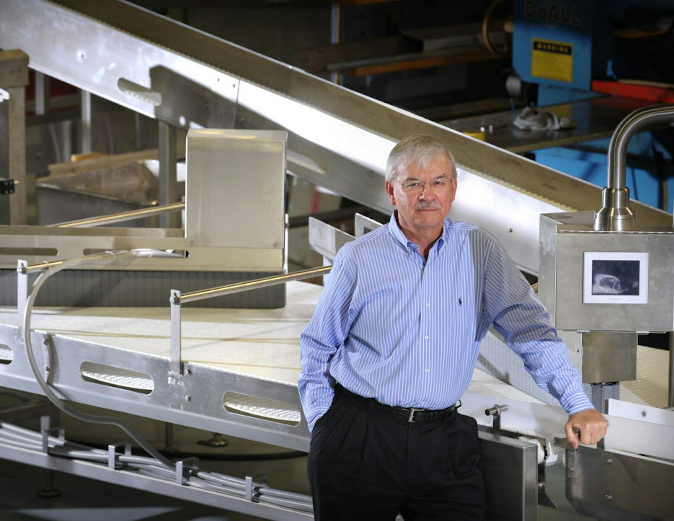 GLEN STUBBE ï gstubbe@startribune.com -- Tuesday , June 16, 2009 -- Burnsville, Minn. -- ] Gary Hadley, president, MultiSource Manufacturing, with a machine that can sort and package 1000 frozen pancakes every minute heading for a Tennessee customer .