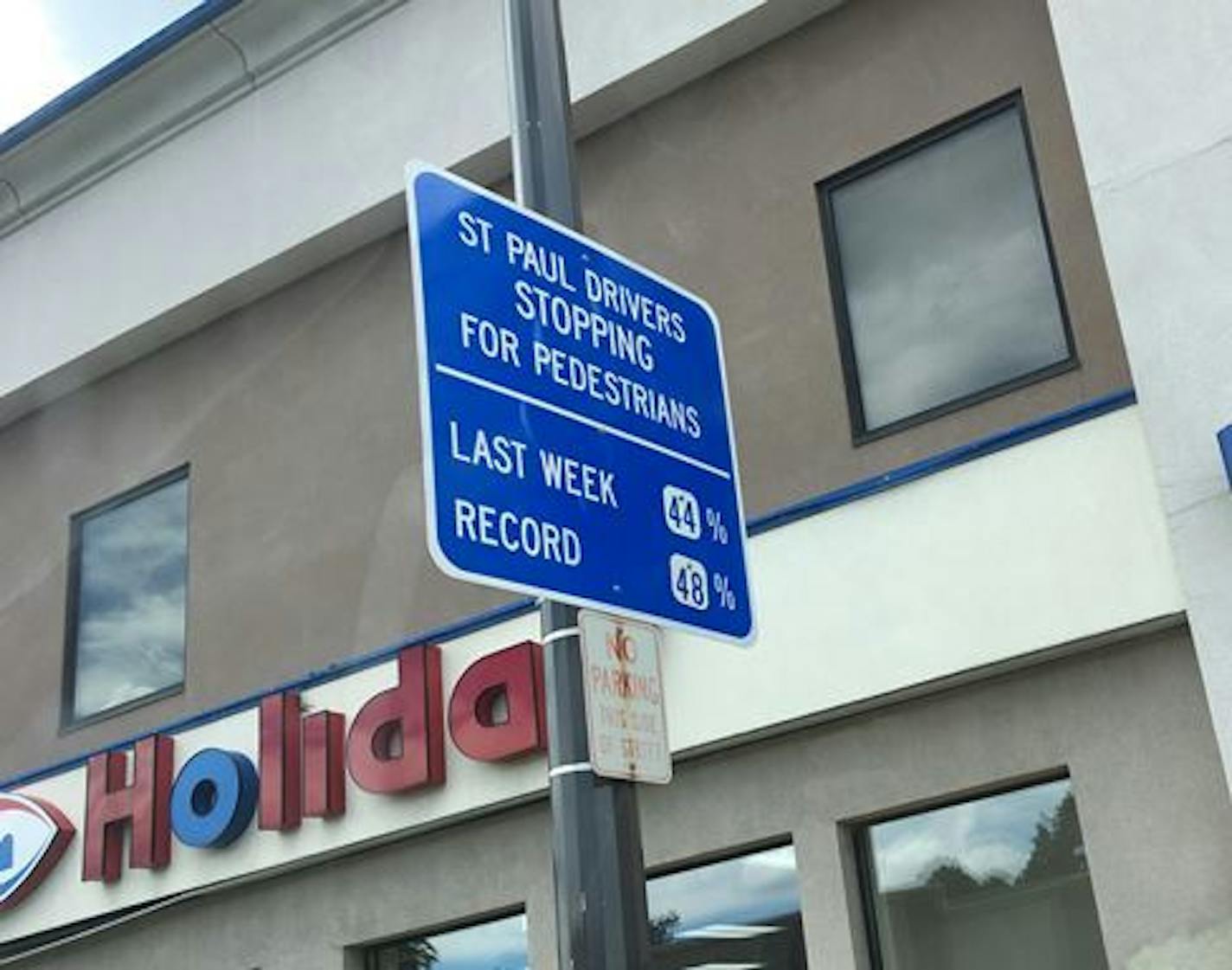 Signs in St. Paul seek to get drivers to stop for pedestrians in crosswalks.