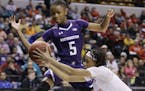 FILE - In this March 5, 2016, file photo, Northwestern's Jordan Hankins (5) and Maryland's Brene Moseley (3) reach for a loose ball during an NCAA col
