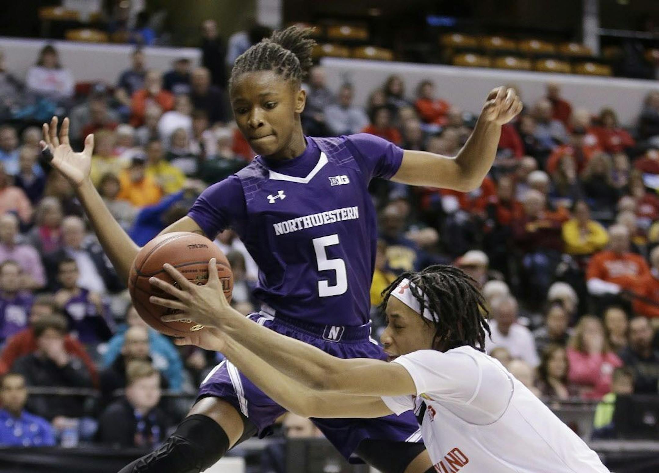FILE - In this March 5, 2016, file photo, Northwestern's Jordan Hankins (5) and Maryland's Brene Moseley (3) reach for a loose ball during an NCAA college basketball game at the Big Ten Conference tournament in Indianapolis. Hankins has been found dead in her room at the university.