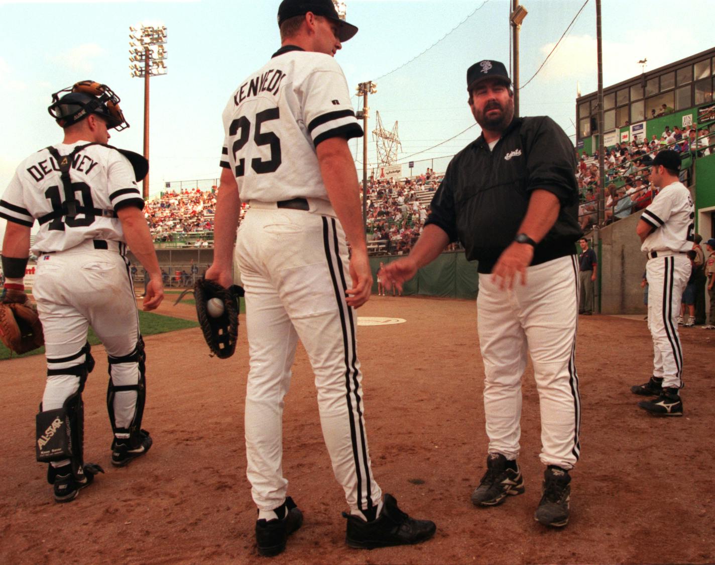 Former Saints manager Marty Scott, right, directs his players at Midway Stadium in the 1990s.