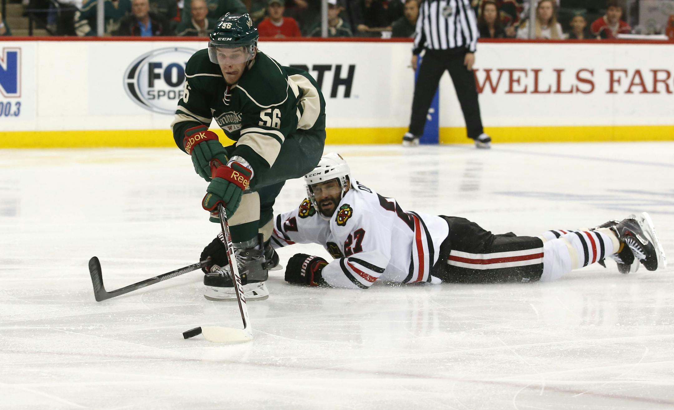 Minnesota Wild left wing Erik Haula (56) skated passed the fallen Chicago Blackhawks defenseman Johnny Oduya (27) to score to tie up the game during the second period. ] CARLOS GONZALEZ cgonzalez@startribune.com - May 13, 2014, St. Paul, Minn., Xcel Energy Center, NHL, Minnesota Wild vs. Chicago Blackhawks, Stanley Cup Playoffs Round 2, Game 6