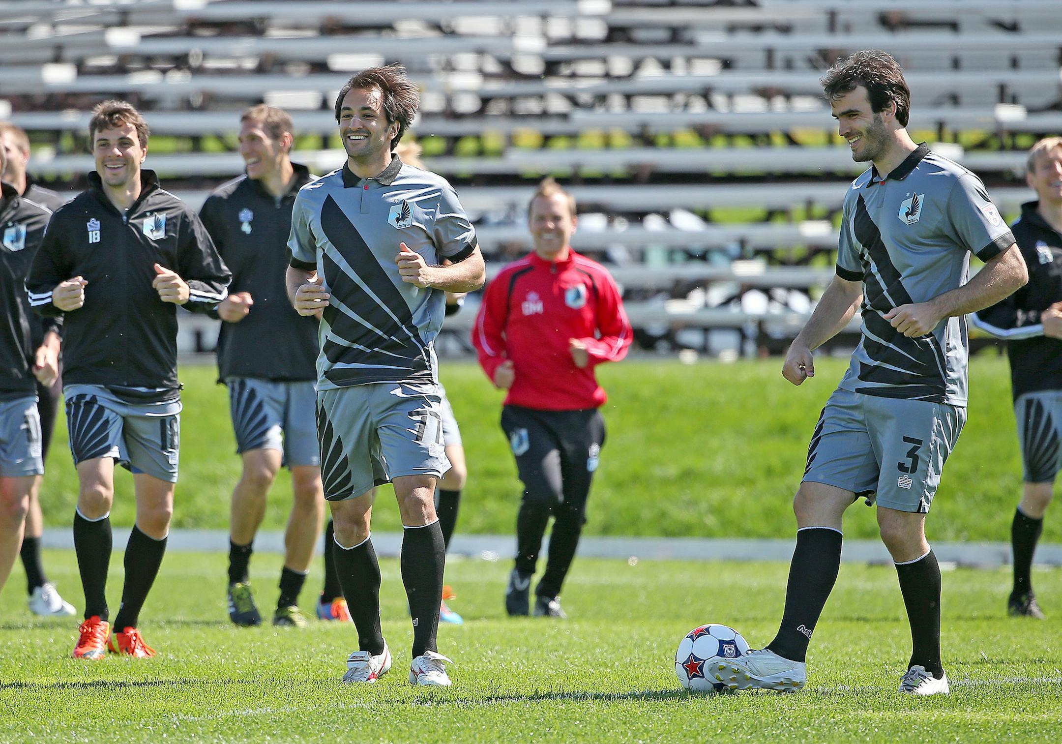 Minnesota United's players, including, Juliano Vicentini, center, warmed up on the field before practice, Wednesday, May 21, 2014 at the National Sports Center in Blaine.