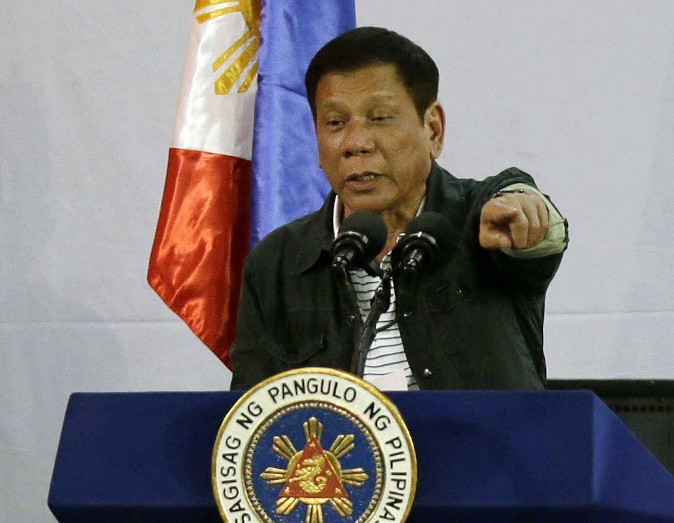 FILE - In this June 30, 2016, file photo, Philippine President Rodrigo Duterte gestures as he delivers his speech before a solidarity dinner with the poor event at a slum area in Manila, Philippines. Duterte blamed U.S. intervention for the bloody conflicts in Iraq and other Middle Eastern countries in his latest critical remark against Manila's closest security ally. Duterte suggested in a speech to Muslims on Friday, July 8, 2016, that U.S. policy was to blame for terrorist attacks on its soil