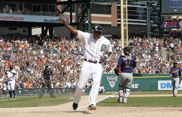Detroit Tigers' Torii Hunter celebrates as he scores on a J.D. Martinez walkoff sacrifice fly against the Minnesota Twins in the ninth inning of a bas