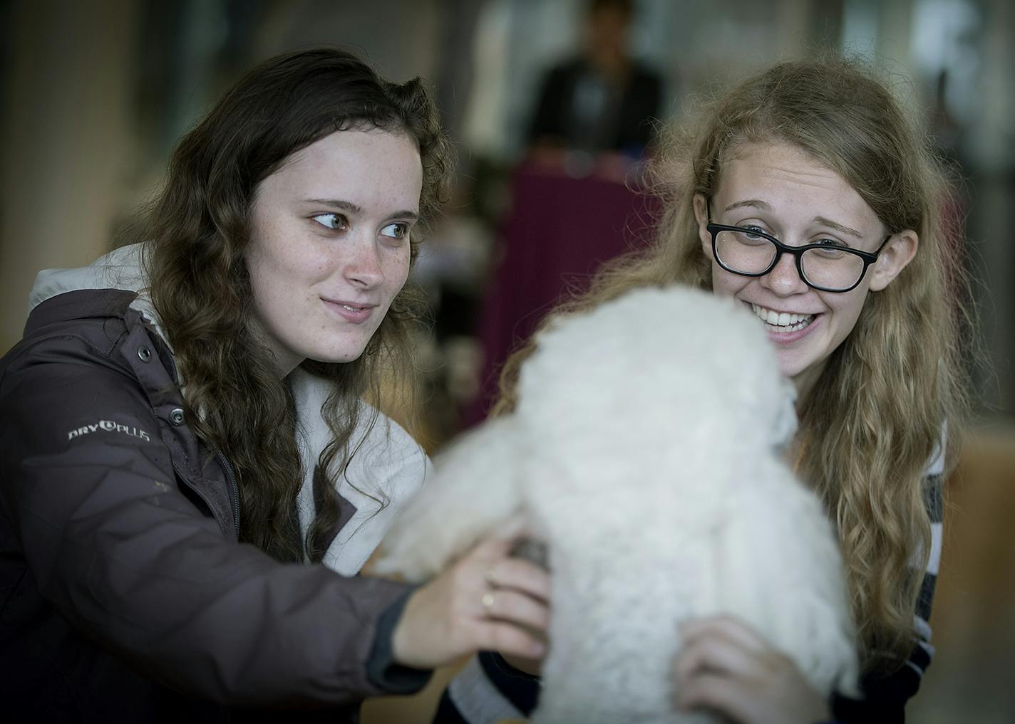 U of M freshmen Signe Blake, left, and Kaitlyn O'Shea found comfort as they played with Dottie at the University of Minnesota Recreation and Wellness Center.