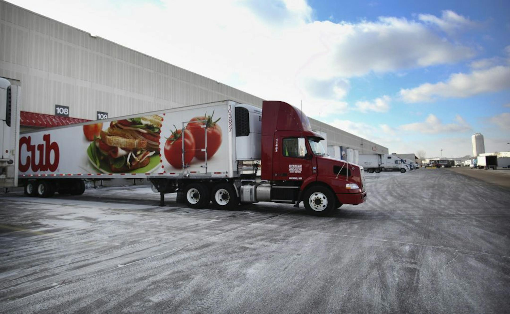 Tractor trailers are lined up at Supervalu's grocery distribution center in Hopkins.