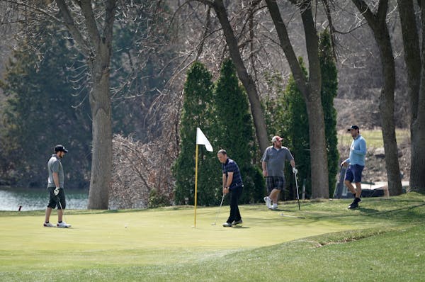Golfers at Stonebrooke Golf Club in Shakopee enjoyed Friday's spring weather but took care to practice social distancing.