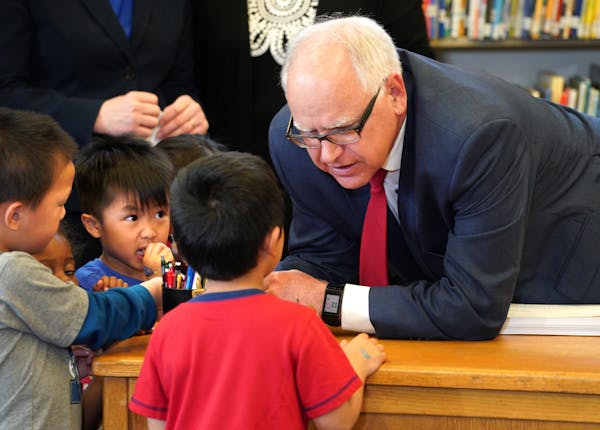 Under the watchful eye of Pre-K children from Bruce Vento Elementary School in St. Paul, Governor Tim Walz signed the school funding bill into law, an