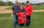 From left, Steve Branca, Mary Branca Rosenow and Denny Branca show off the framed uniform that the Rochester John Marshall baseball program gave them 
