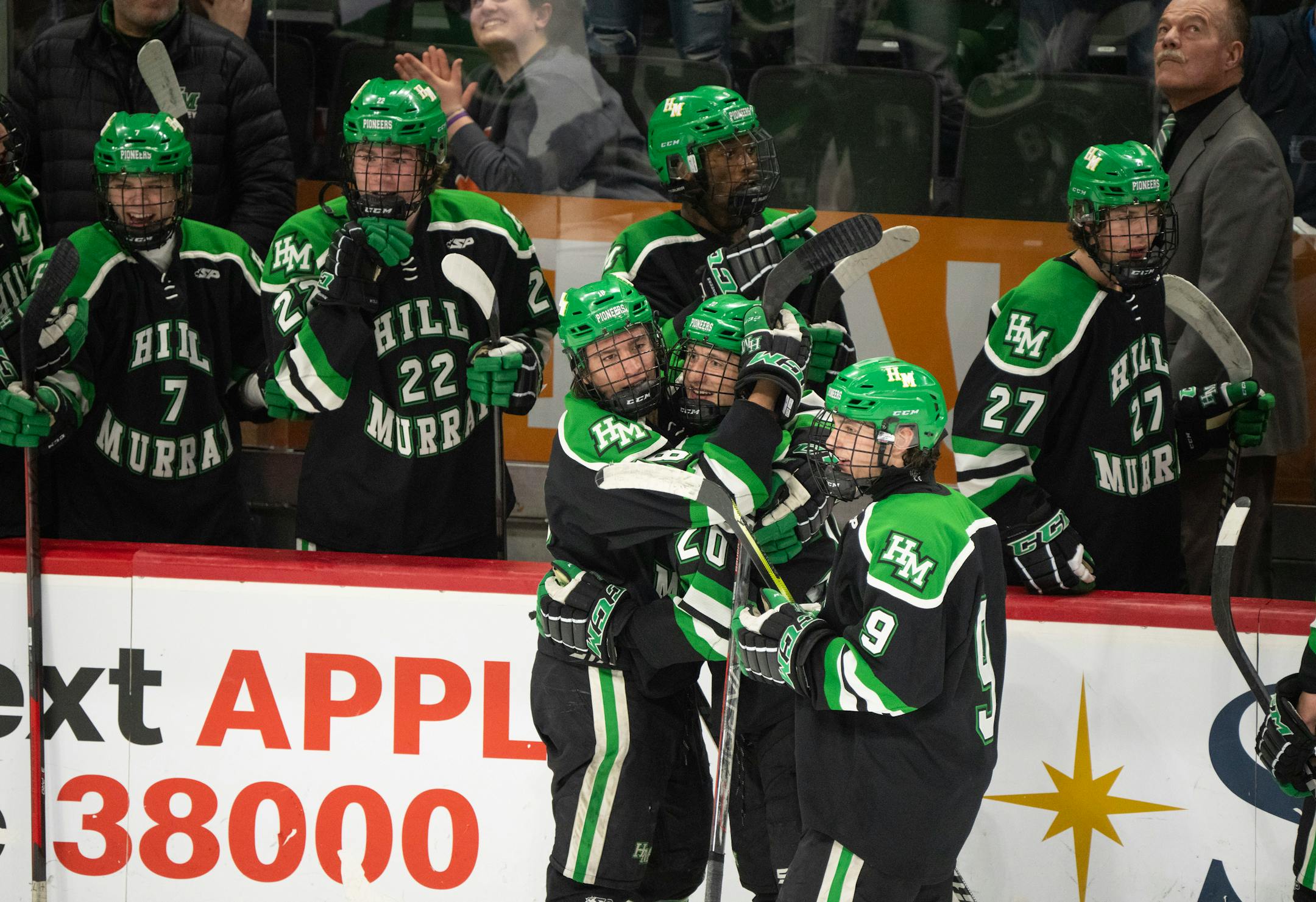Hill-Murray Pioneers defenseman Landon Cottingham (20), center, was congratulated after his go ahead goal in the third period.
