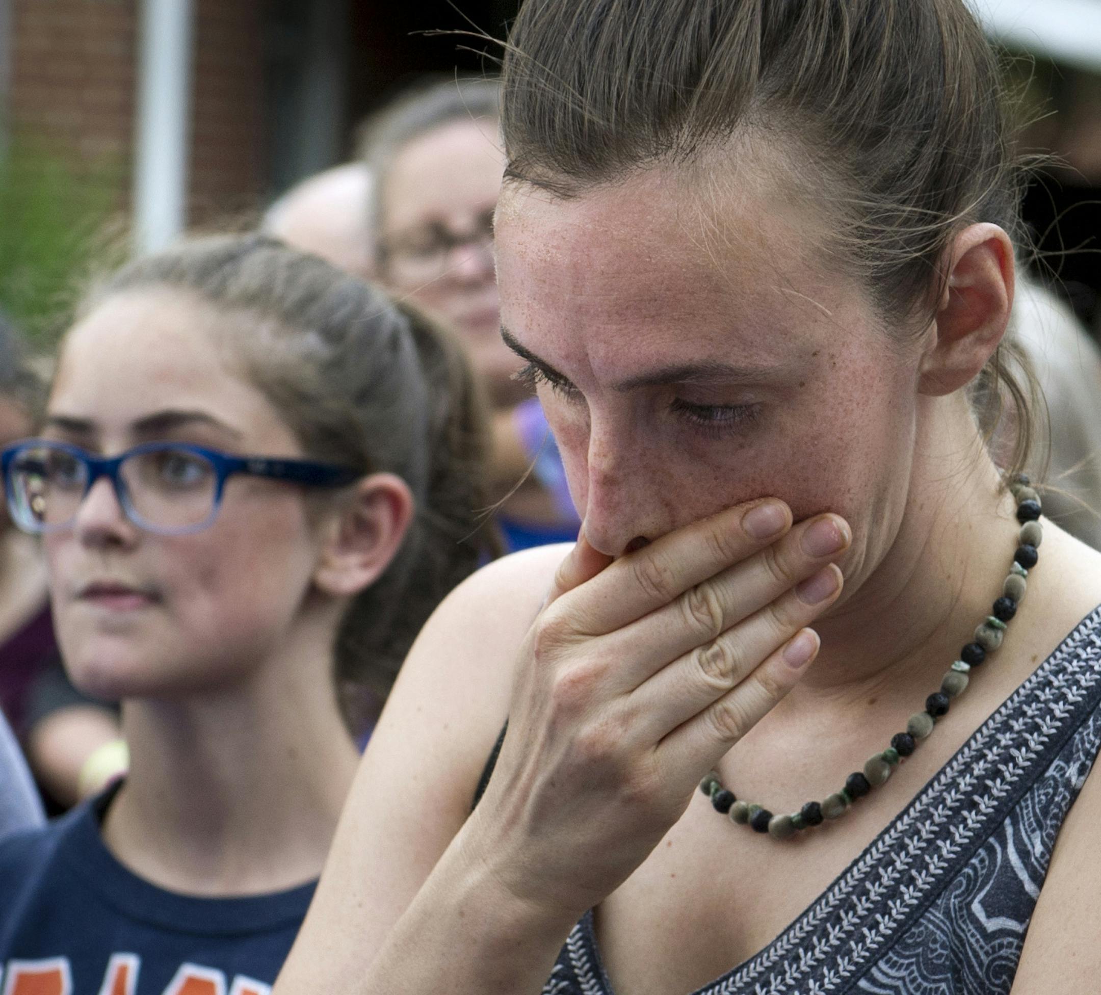 Residents gather to say a prayer near the baseball field, the scene of a multiple shooting in Alexandria, Va., Wednesday, June 14, 2017. A rifle-wielding attacker opened fire on Republican lawmakers at a congressional baseball practice, wounding House GOP Whip Steve Scalise of Louisiana and several others as congressmen and aides dove for cover. (AP Photo/Cliff Owen)