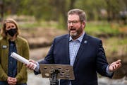Hennepin County Commissioner Chris LaTondresse, right, with Laura Domyancich of the Minnehaha Creek Watershed District at Arden Park in Edina in May 2