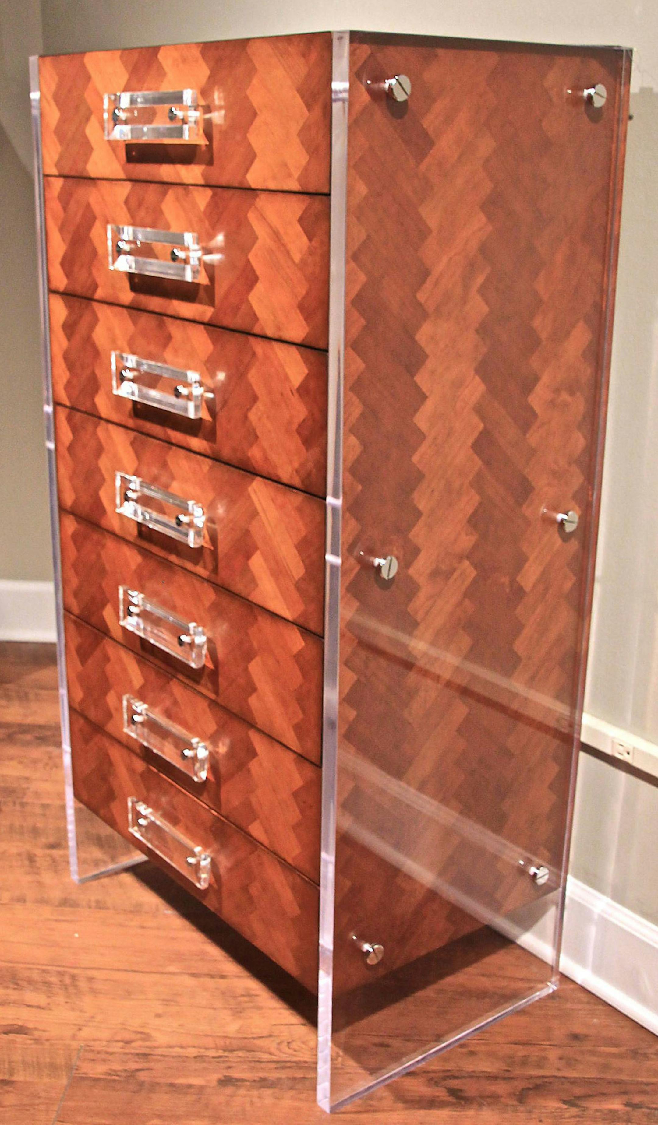 The Reese chevron-patterned tall chest from French Heritage has an antique cherry finish with acrylic panels and drawer pulls. (Patricia Sheridan/Pittsburgh Post-Gazette/TNS) ORG XMIT: 1187682