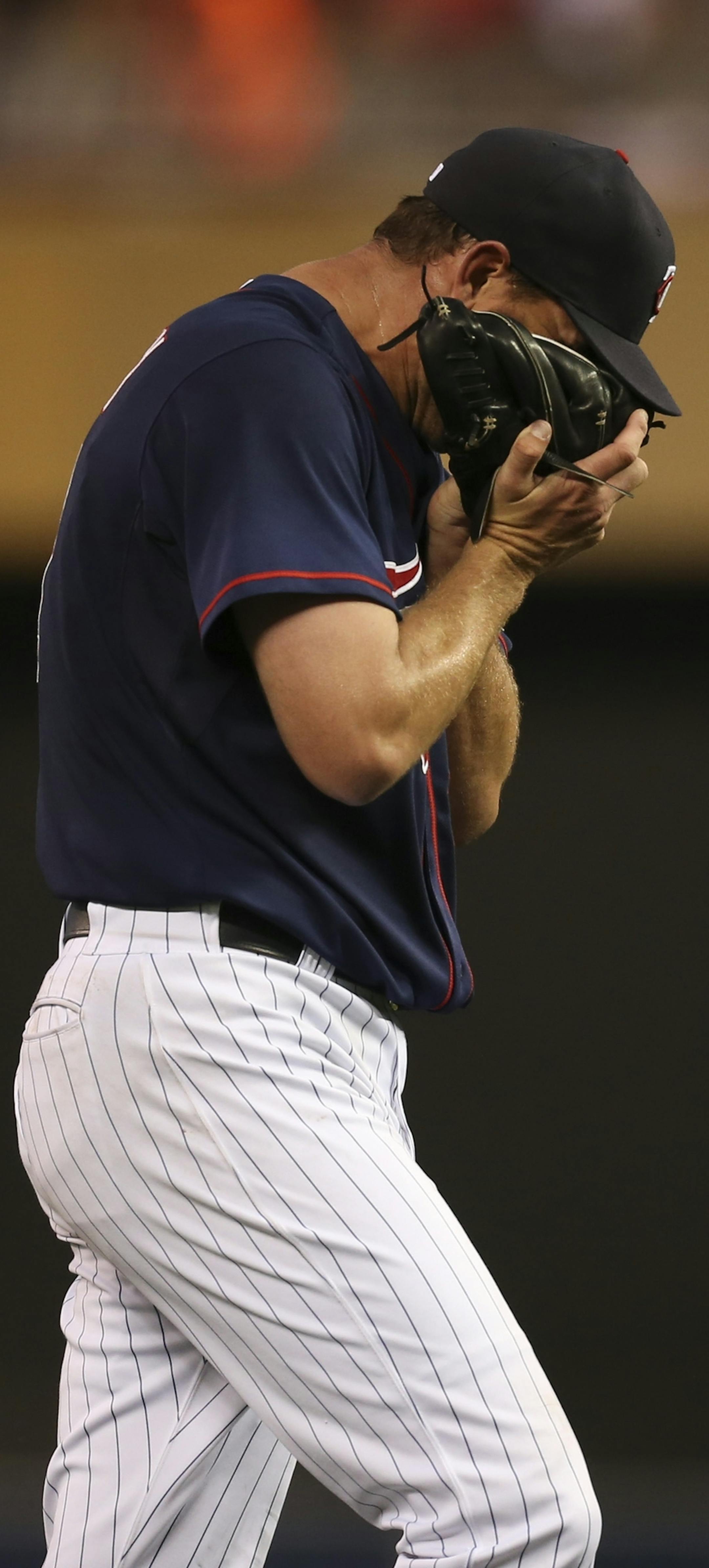 The MInnesota Twins lost the first game of their series with the Kansas City Royals 7-2 Tuesday night, July 30, 2013 at Target Field in Minneapolis. Twins starting pitcher Mike Pelfrey buried his face in his glove as he walked off the mound in the third inning after giving up a three run homer to the Royals' Mike Moustakas. ] JEFF WHEELER &#x201a;&#xc4;&#xa2; jeff.wheeler@startribune.com ORG XMIT: MIN1307302253134519