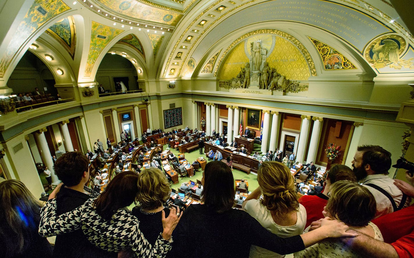 FILE - In this May 9, 2014 file photo, Medical marijuana advocates gather at the Capitol in St. Paul, Minn., to watch as lawmakers pass a bill legalizing limited forms of medical marijuana for a handful of serious conditions like cancer and AIDS. State officials say they will hold off until 2016 at the earliest on deciding whether to expand the new medical marijuana program to residents suffering chronic pain. (AP Photo/The Star Tribune, Glen Stubbe, File)