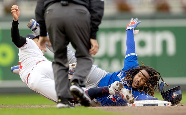 Twins shortstop Carlos Correa applied the tag as Toronto’s Vladimir Guerrero Jr. was picked off second in the fifth inning on Tuesday.