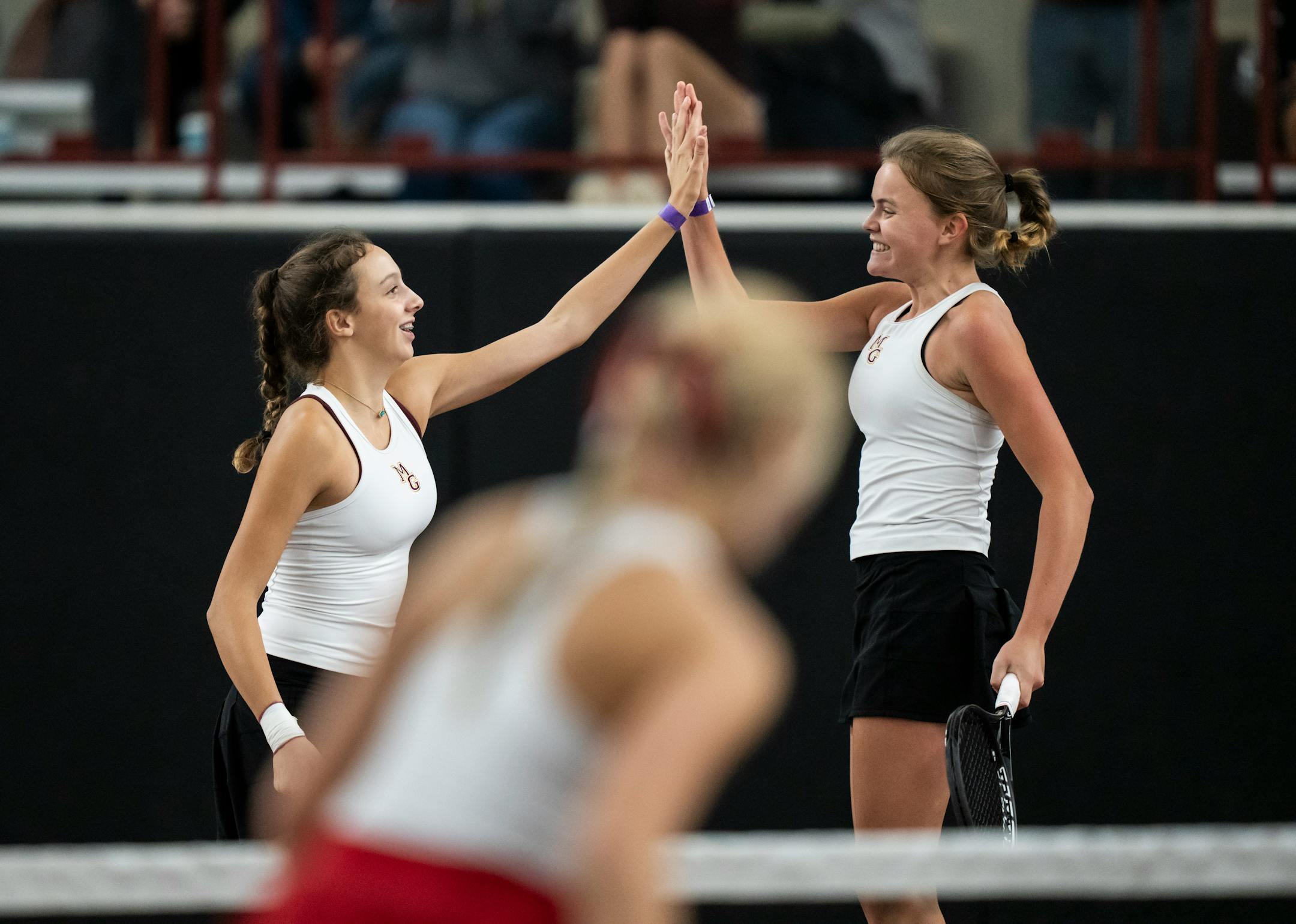 Maple Grove's first doubles players Lexi Helmer-Jahnke and Amelia Larsen celebrate winning the first set against Elk River during the Class 2A team girls tennis quarterfinals.