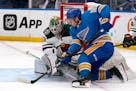 St. Louis Blues' Robert Thomas, right, is unable to score past Minnesota Wild goaltender Cam Talbot during the second period of an NHL hockey game Sat