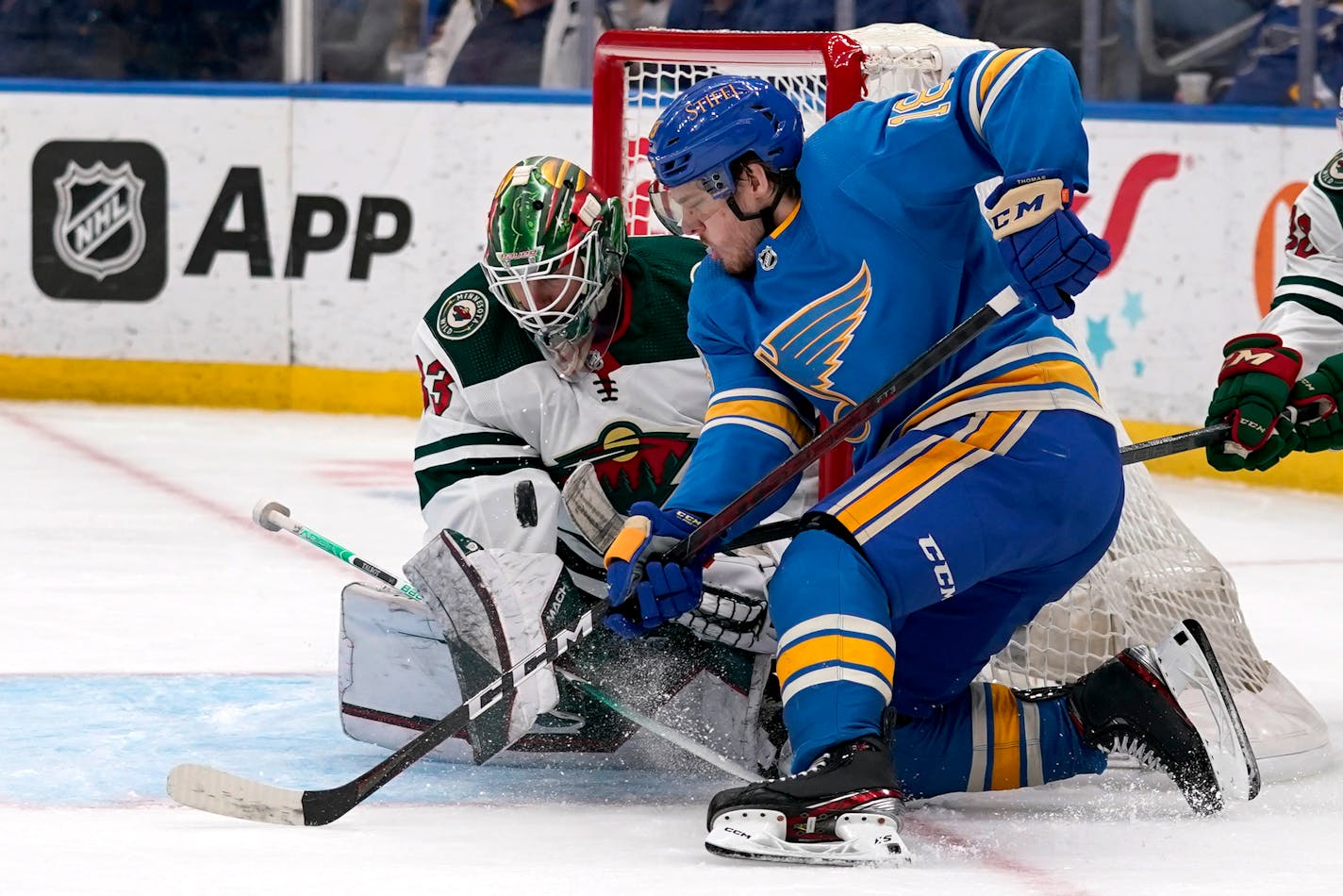 St. Louis Blues' Robert Thomas, right, is unable to score past Minnesota Wild goaltender Cam Talbot during the second period of an NHL hockey game Saturday, April 16, 2022, in St. Louis. (AP Photo/Jeff Roberson)