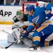 St. Louis Blues' Robert Thomas, right, is unable to score past Minnesota Wild goaltender Cam Talbot during the second period of an NHL hockey game Sat