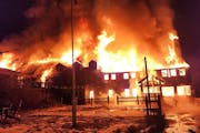 Flames engulf the Lutsen Lodge early Tuesday morning after a fire broke out on the property in Lutsen. The historic lodge is located on the North Shor