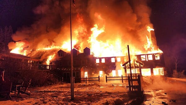Flames engulf the Lutsen Lodge early Tuesday morning after a fire broke out on the property in Lutsen. The historic lodge is located on the North Shor