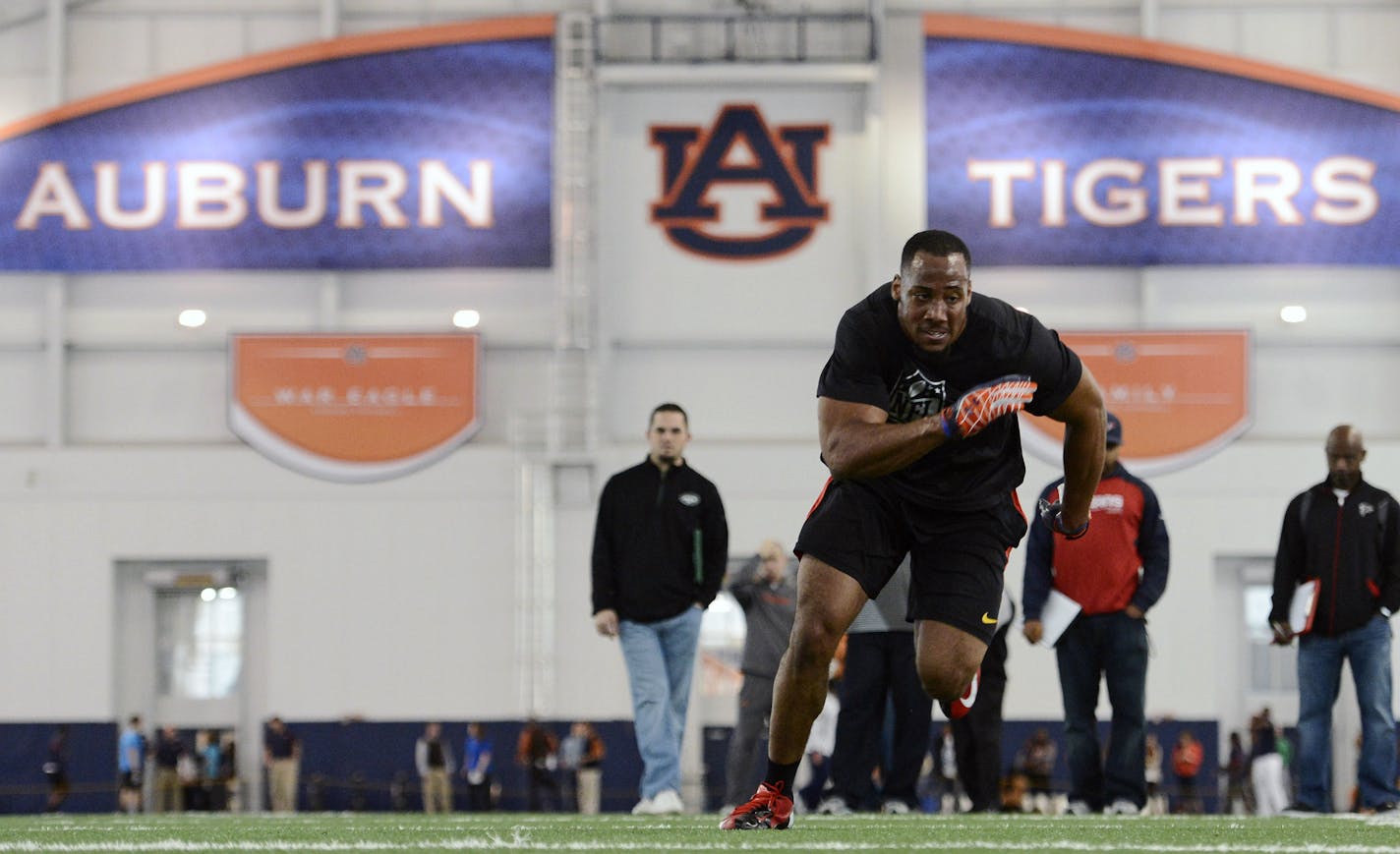 Former Auburn defender Corey Lemonier runs linebacker drills for scouts during Auburn's NFL football pro day on Tuesday, March 5, 2013 in Auburn, Ala. (AP Photo/Todd J. Van Emst)