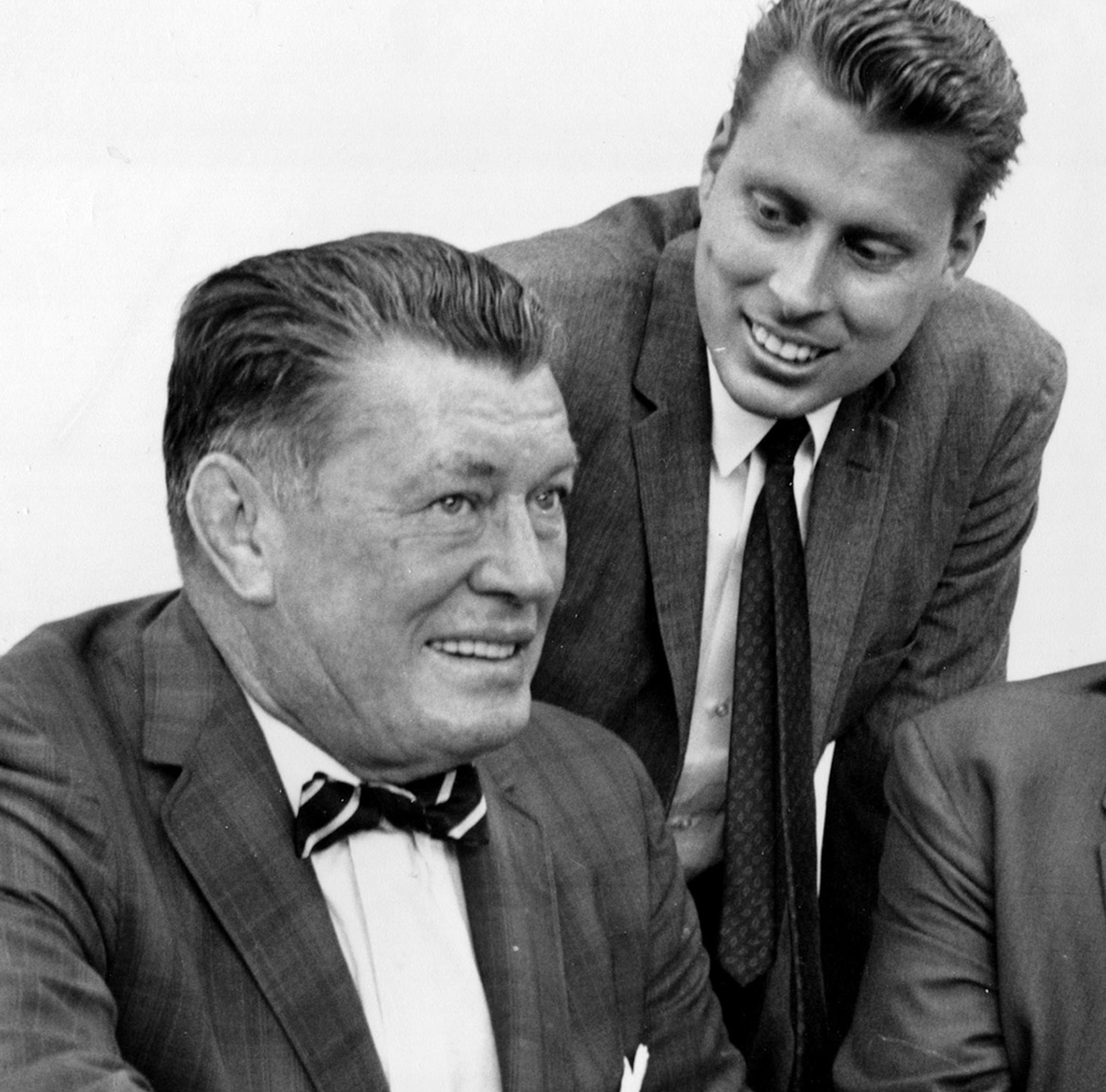 FILE - In this Sept. 23, 1964 file photo, boxing heavyweights Gene Tunney, left, and Jack Dempsey, right, pose with Tunney's son, John V. Tunney, at a news conference in Los Angeles. John Tunney, the former U.S. senator from California, has died. His brother Jay Tunney says John Tunney died Friday, Jan. 12, 2018 in Santa Monica, Calif., of cancer. He was 83. John Tunney was the son of heavyweight boxing champion Gene Tunney, and was among the youngest people elected to the U.S. Senate in the pas
