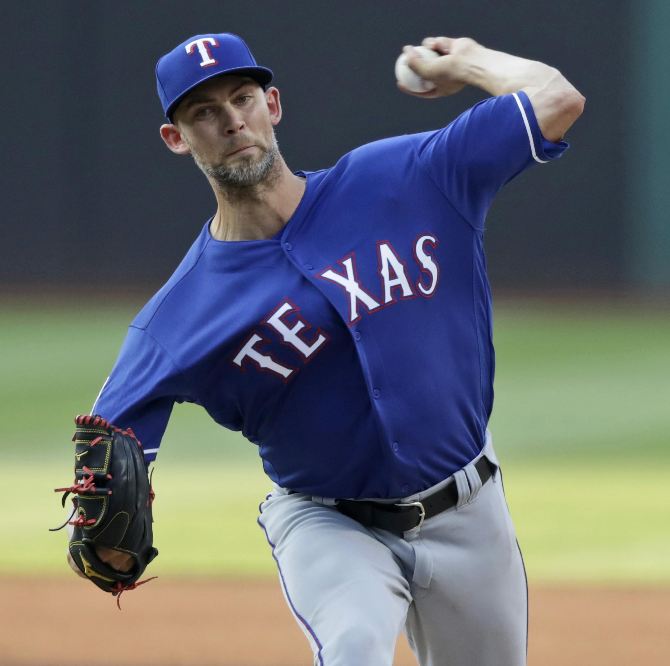 Texas Rangers starting pitcher Mike Minor delivers in the first inning in a baseball game against the Cleveland Indians, Monday, Aug. 5, 2019, in Cleveland. (AP Photo/Tony Dejak)